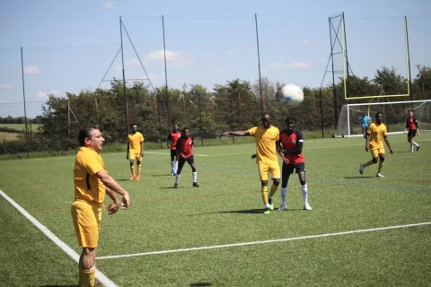 Player in yellow taking a throw-in.